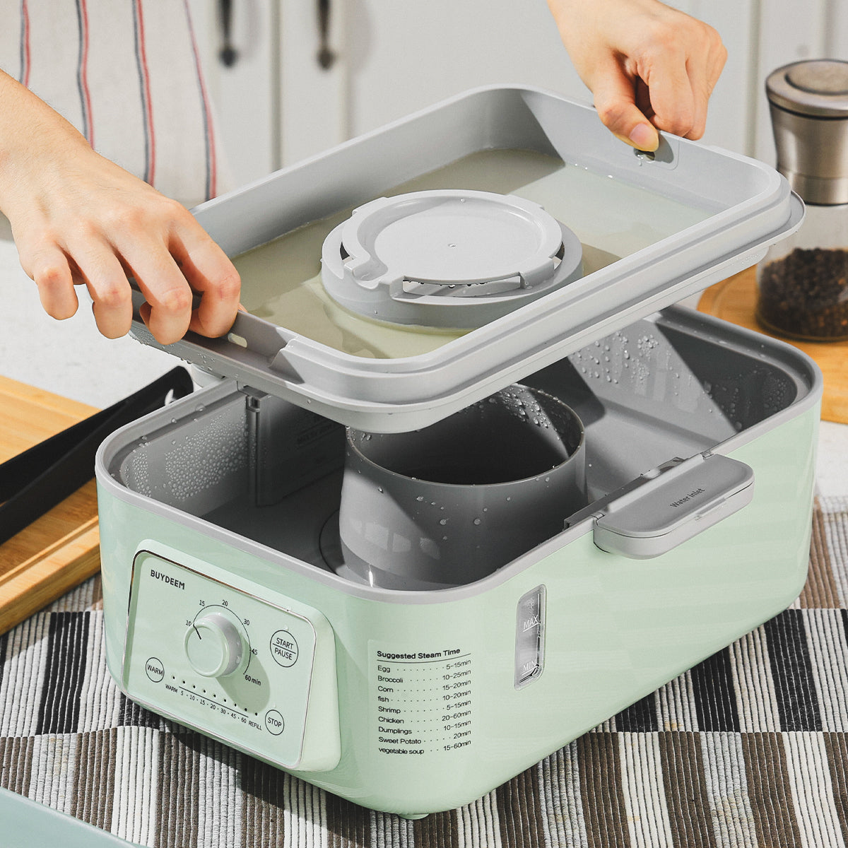 Person using a green kitchen appliance on a striped tablecloth.